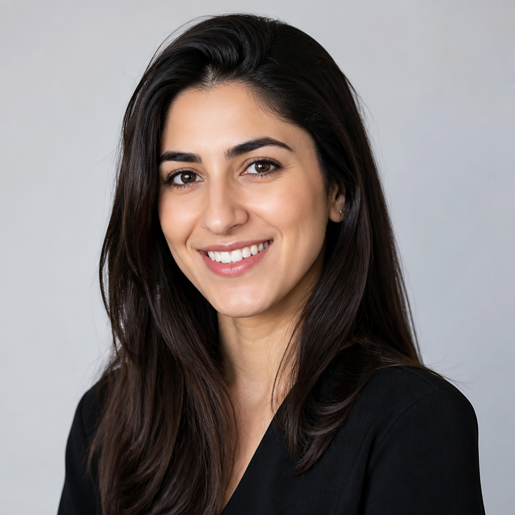Cheerful portrait of a young Middle Eastern woman with long dark hair, bright smile, wearing a colorful top, warm afternoon light, modern Sharjah apartment setting