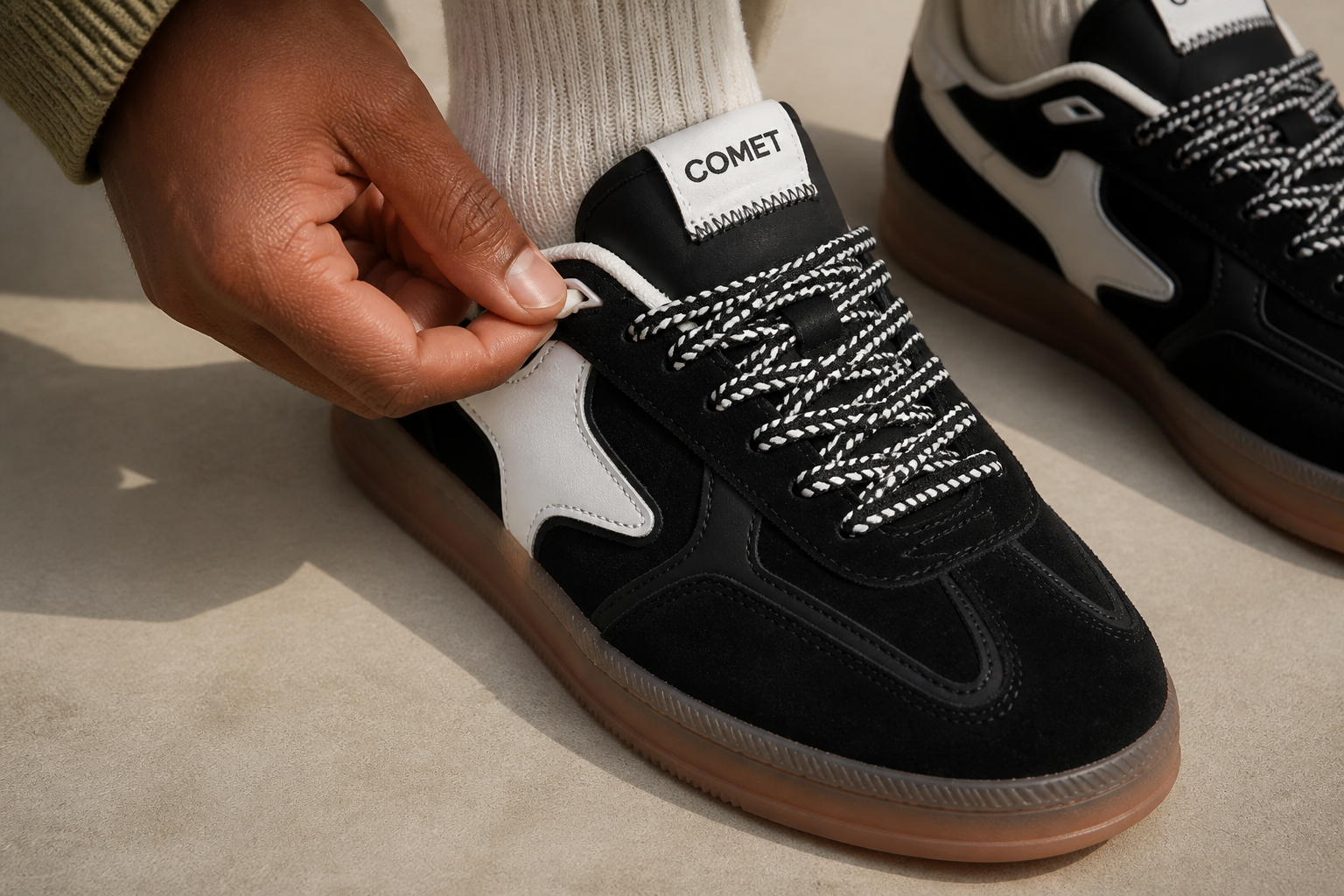 Detail of vintage-style T-toe panel stitching on Aeres NOIR with clean microfibre and contrast white stitching