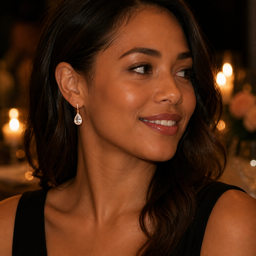 Evening event portrait of a woman in a black dress with the Lunar earrings catching candlelight