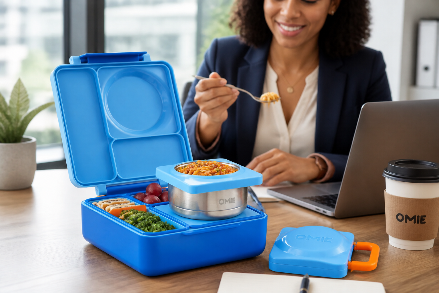 Professional woman in business attire enjoying a hot homemade lunch at her modern office desk with laptop and coffee nearby