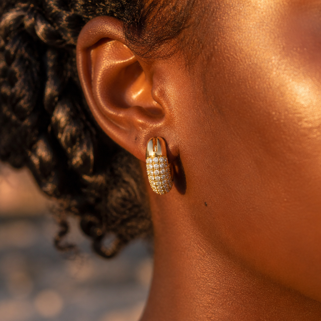 The same ear transformed with glowing Dextera Small pav&eacute; crystal hoops catching golden hour light, every tiny crystal sparkling against the skin