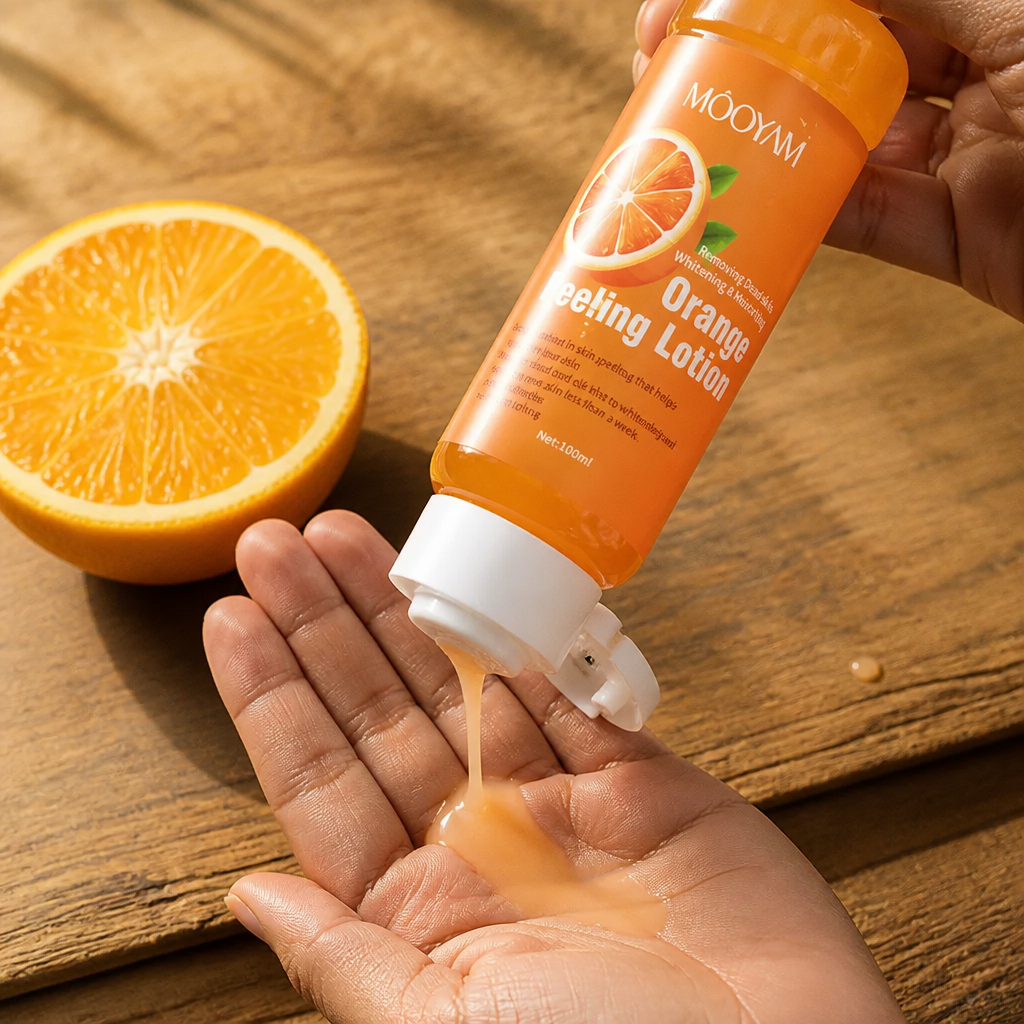 Close-up of peachy-orange lotion being poured into a hand beside a fresh halved orange on a wooden table with warm sunlight