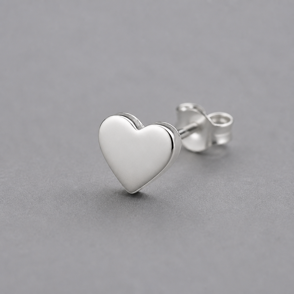Plain unbranded silver heart earring on a generic grey background, simple jewelry, no logos or brand marks visible