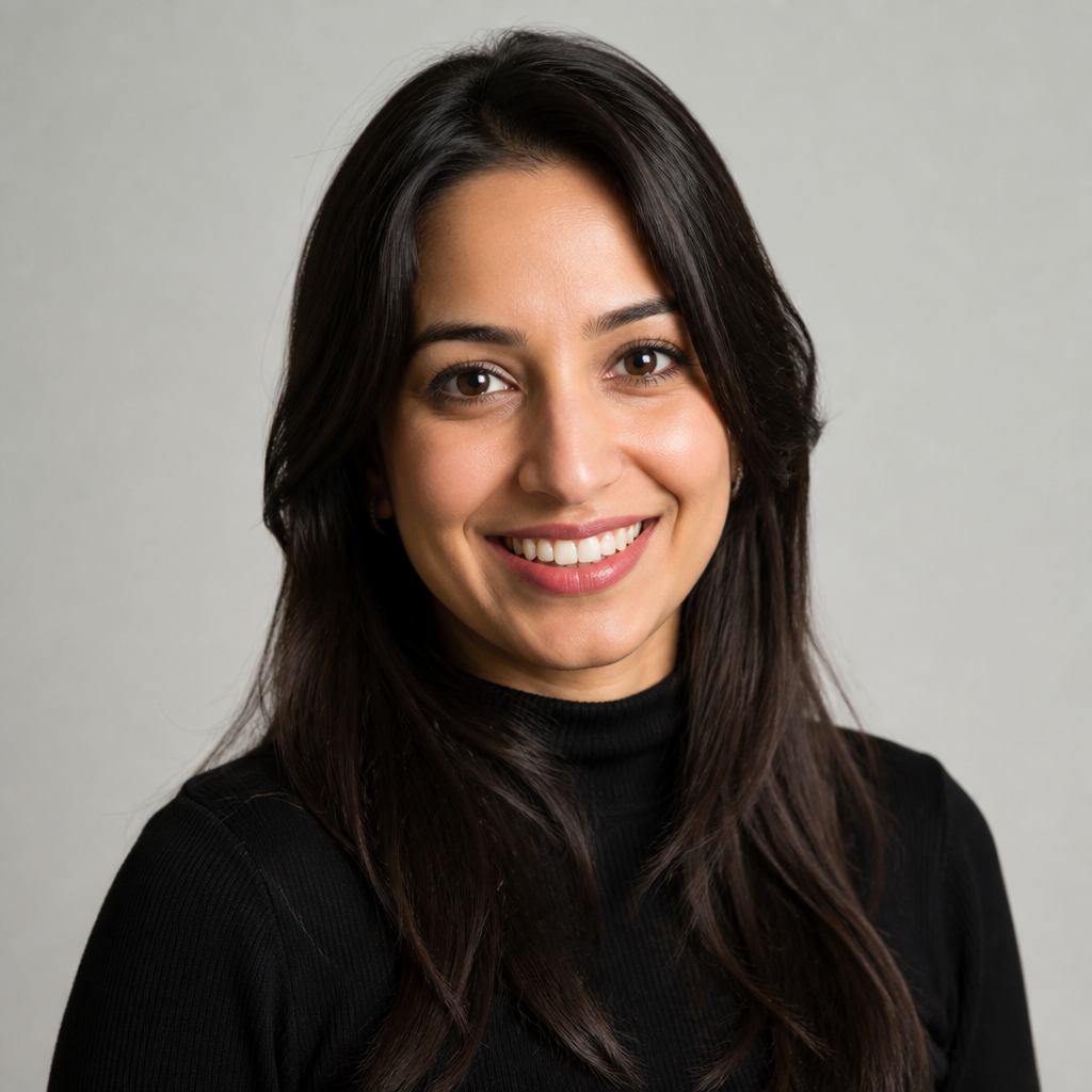 Radiant Indian woman in her early forties with confident natural makeup, soft daylight, candid close-up portrait with shallow depth of field