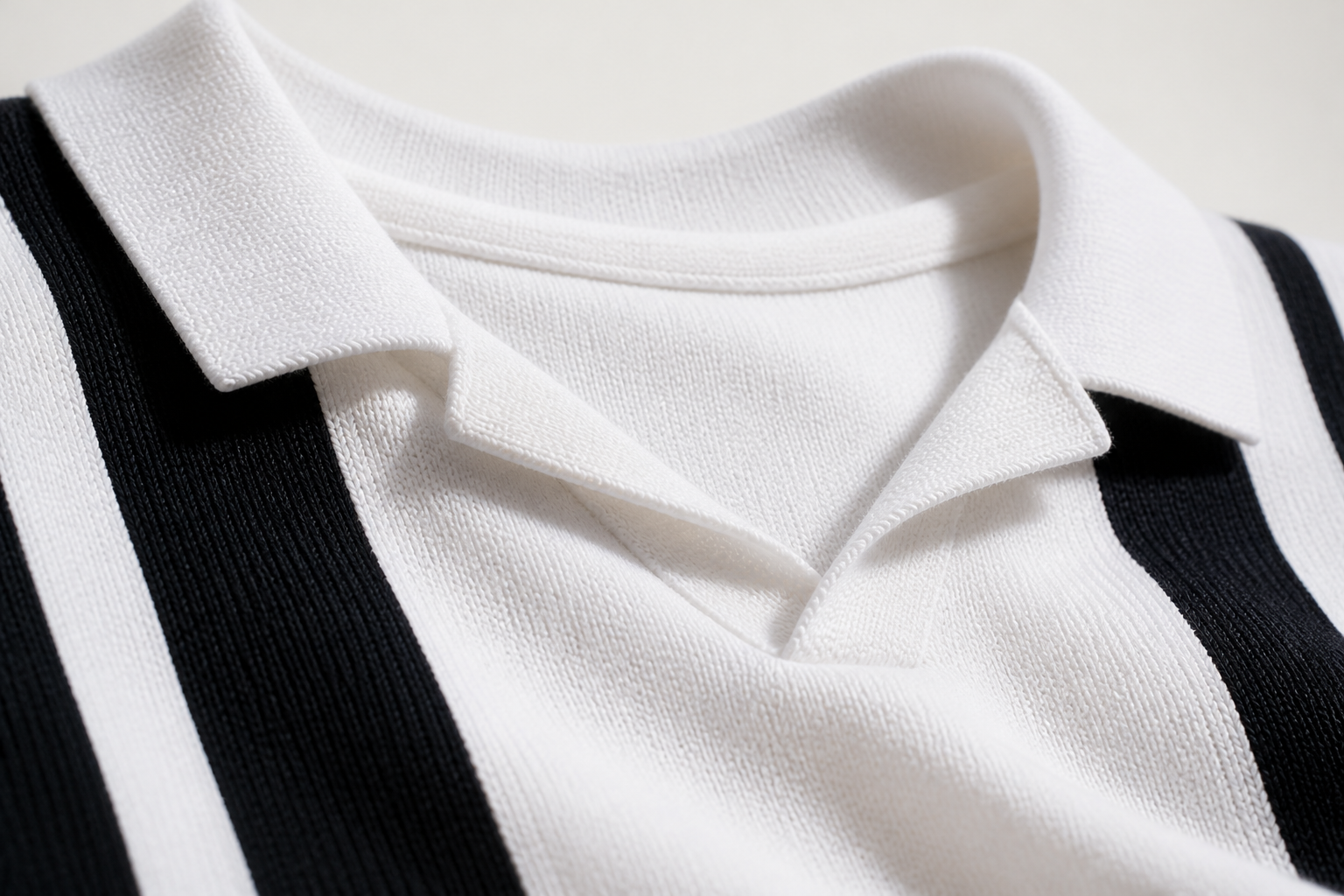 Macro close-up photograph of a structured retro polo collar showing the contrast stripe across the chest and crisp flat-knit cotton fabric texture