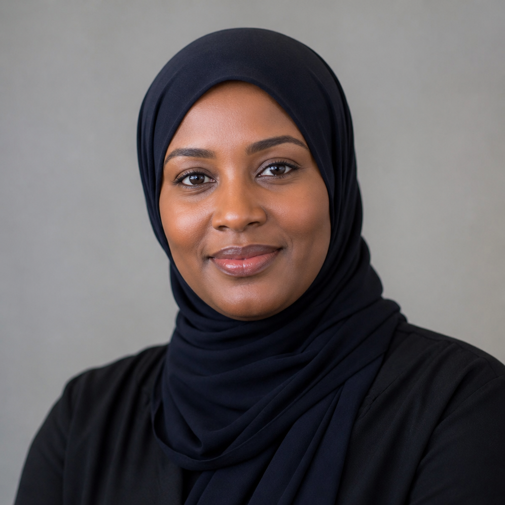 Close-up portrait of Zainab Hassan, a stylish young Kenyan woman wearing elegant gold earrings and a satin blouse, soft studio light and cream backdrop