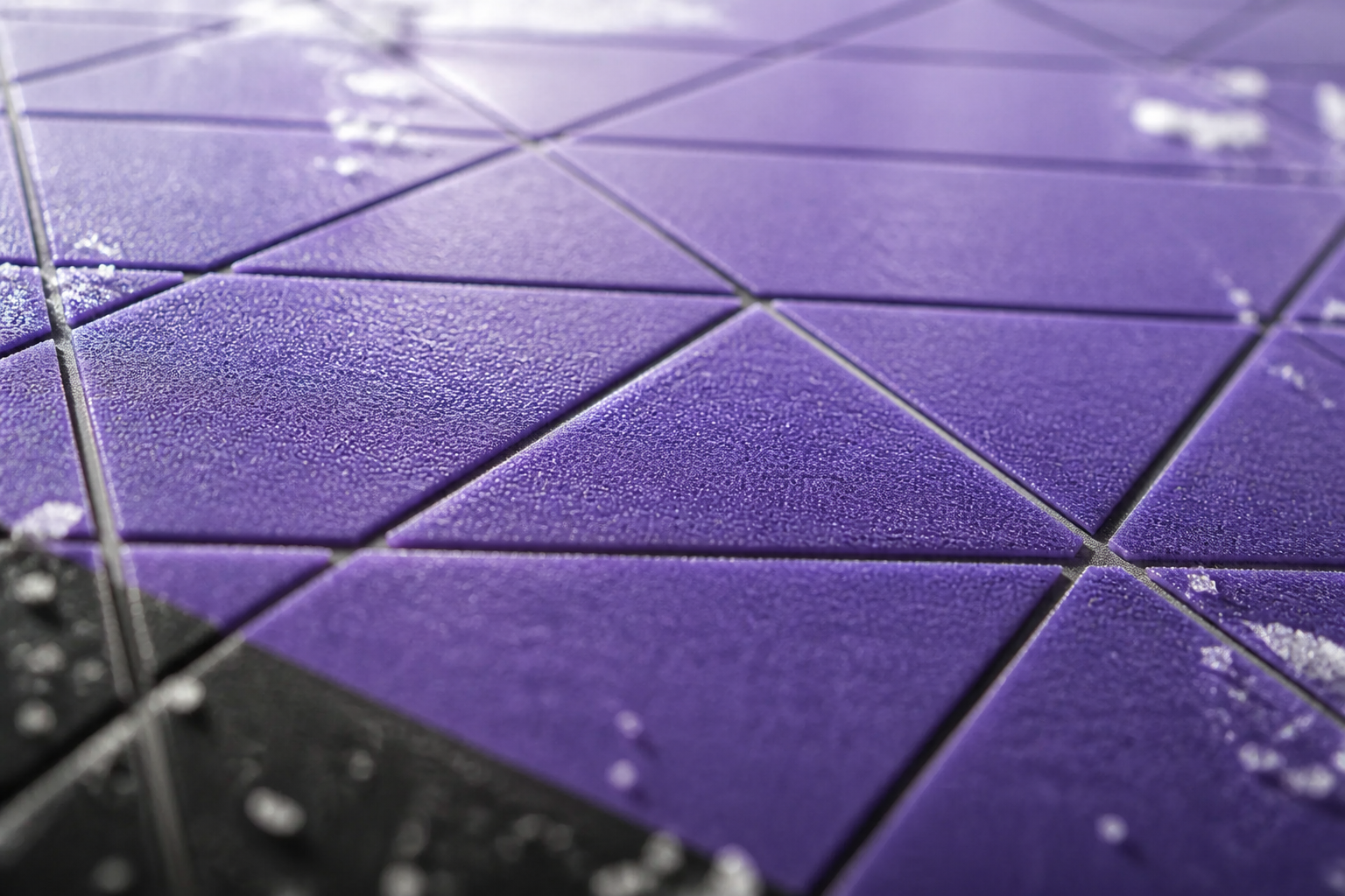 Close-up macro shot of premium snowboard base material texture showing sintered structure and intricate channel pattern with dramatic side-lighting