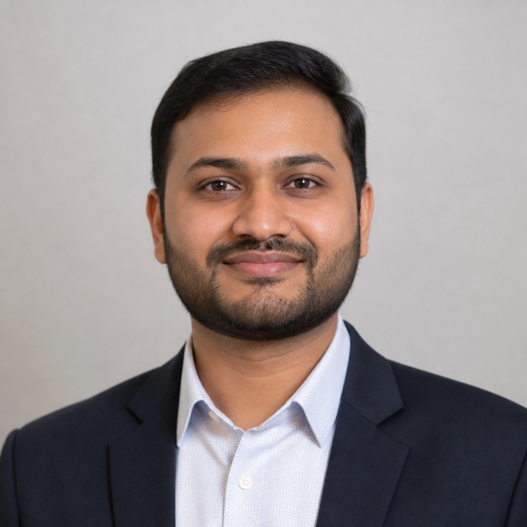 Portrait of an Indian man with short cropped hair and light stubble, warm evening golden-hour lighting, composed thoughtful expression, customer photo