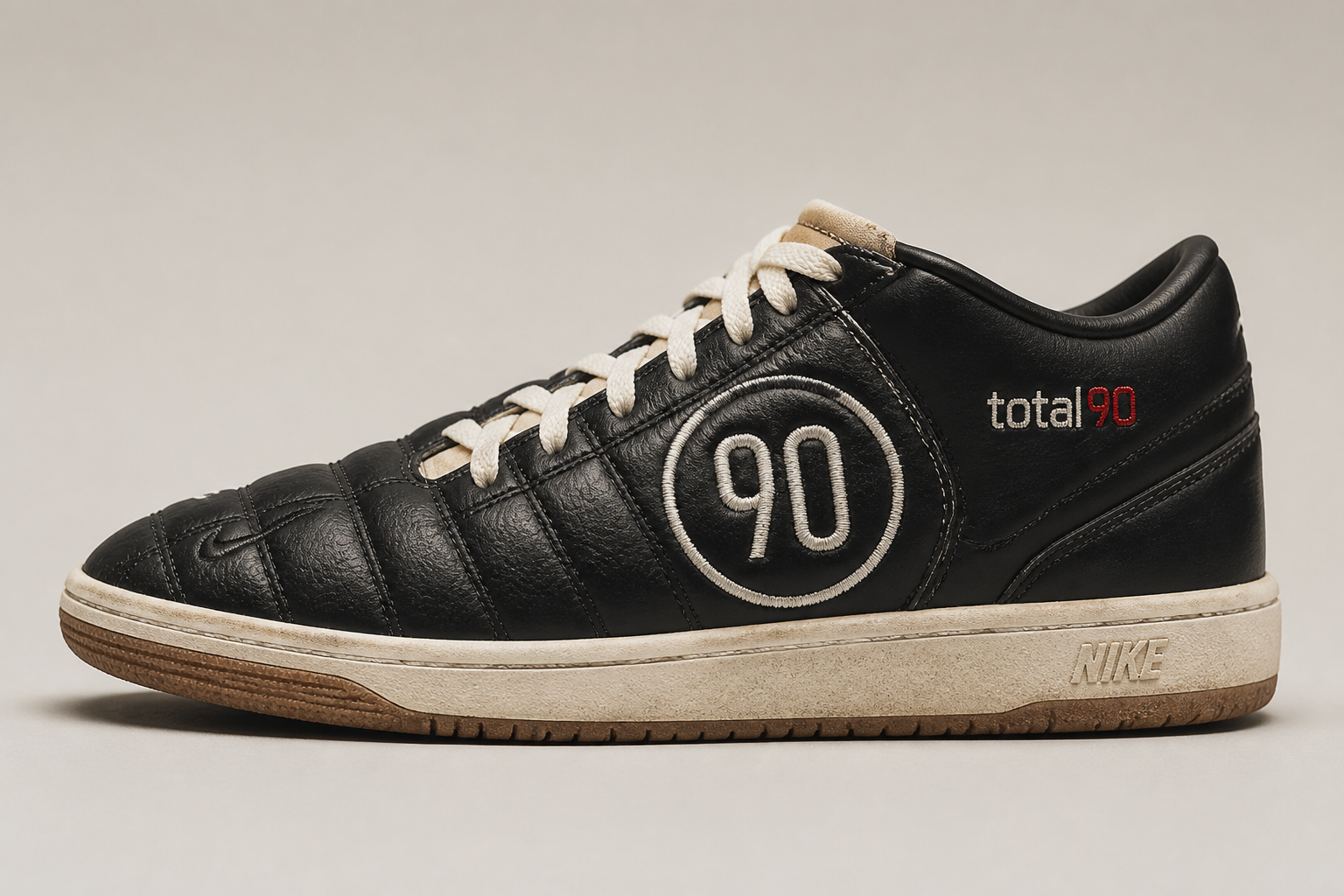 Nike Total 90 Premium sneakers displayed prominently in heritage color palette with distinctive quilted upper and asymmetrical lacing against a clean studio background