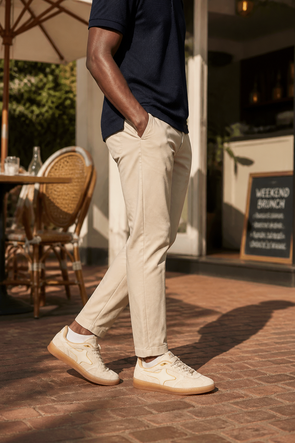 Lifestyle shot of Aeres HALO paired with beige chinos and navy polo shirt for polished weekend brunch ensemble with warm natural lighting