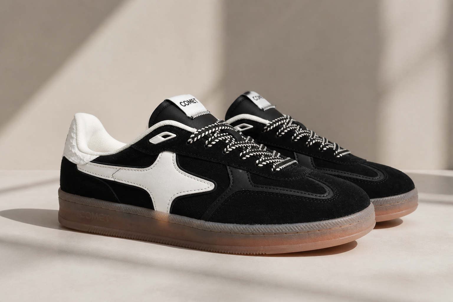 Clean classic Aeres NOIR black suede sneaker with white contrast sole on minimalist neutral background looking refined and timeless