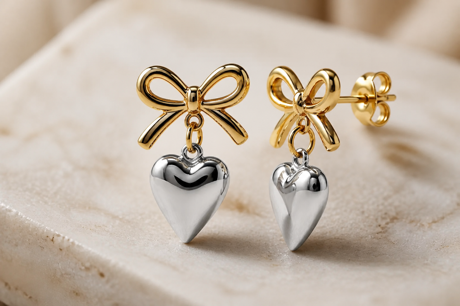 Macro shot showing the bi-metal wrapped knot design detail with intertwined gold and silver tones forming a delicate love heart