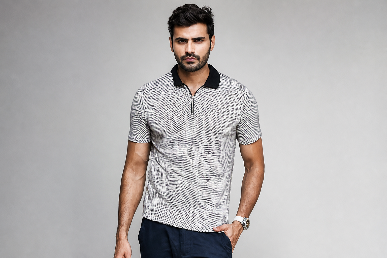 Close-up of the Posh Monk polo's geometric pattern and crisp structured collar on a confident Indian man in soft golden hour light