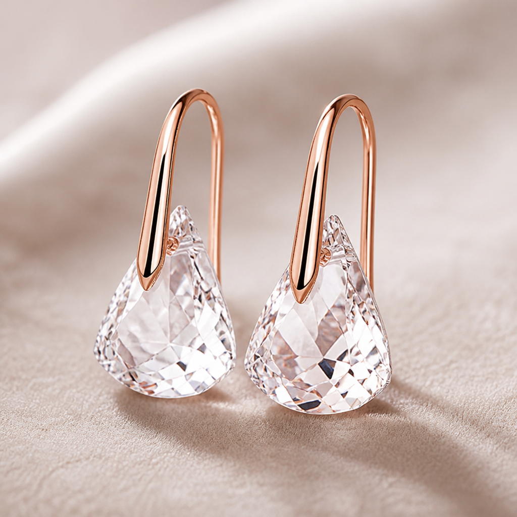 Macro detail photograph showing the 18K rose gold finish texture and fine craftsmanship of the Lunar Drop earring hook and setting against neutral backdrop