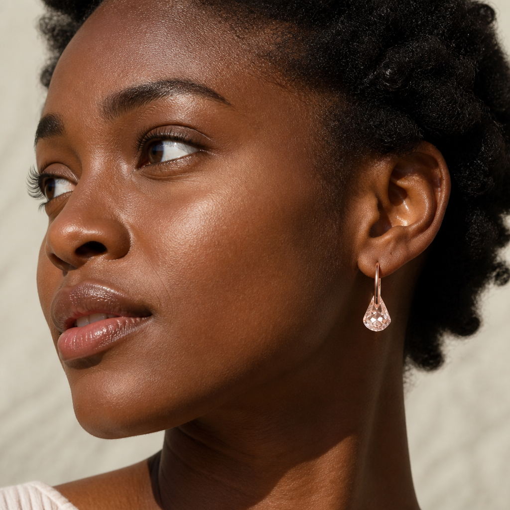 Front view of pink Lunar drop earrings on model showing full design