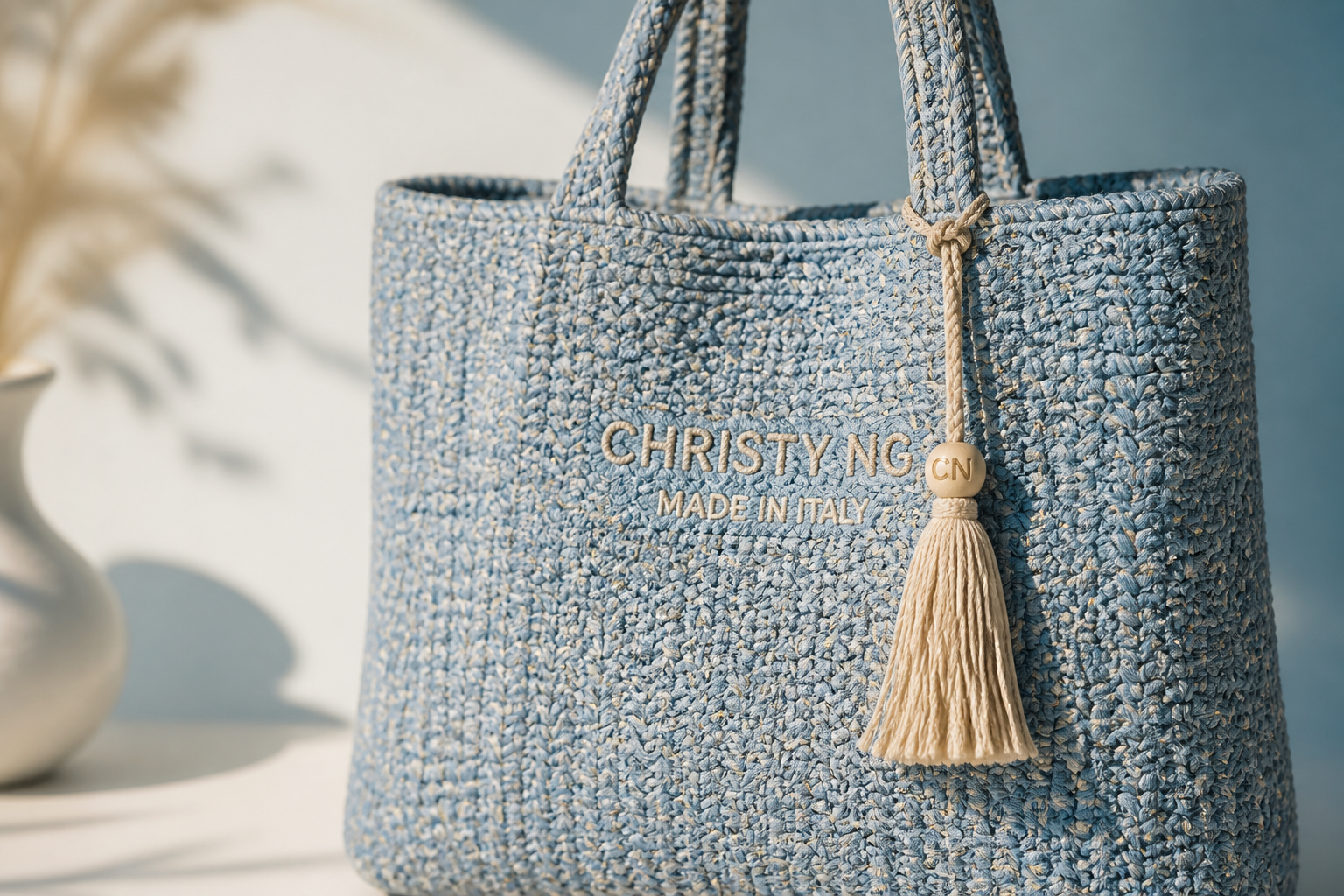 Close-up product shot of the Mini Azure woven tote showing intricate woven texture detail, soft natural sunlight highlighting each weave on a clean pastel background