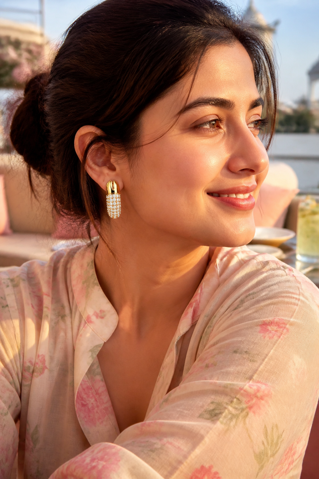 Indian woman in a flowy pastel kurta at a sunny brunch terrace wearing Dextera Small hoops, hair in a loose bun, golden morning light catching the crystals