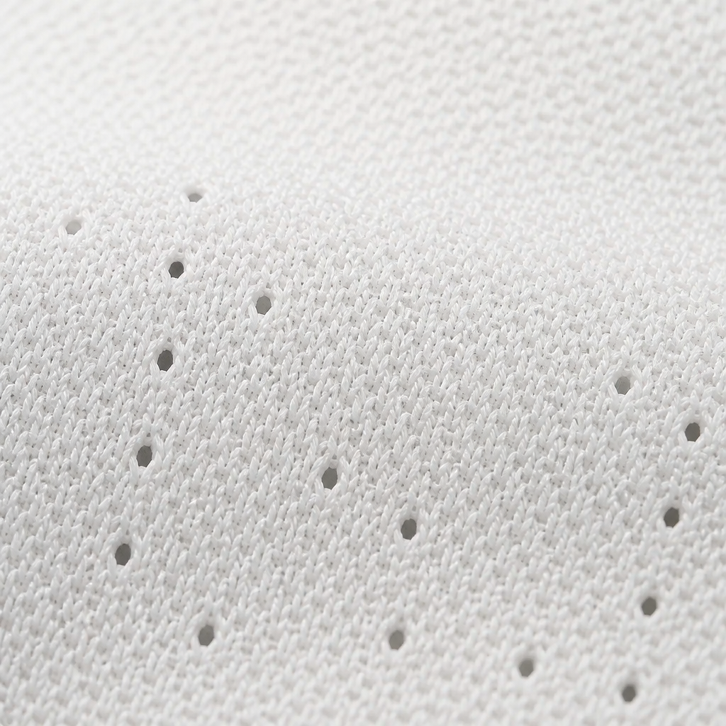 Extreme close-up of breathable mesh upper fabric of Nike Sneakers 3 showing the woven texture and ventilation holes on a clean white surface with soft shadow