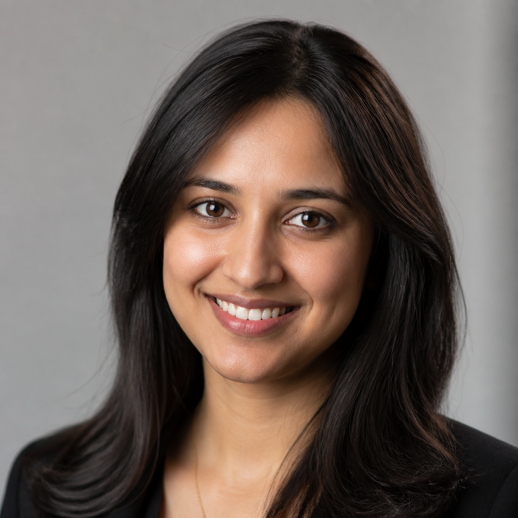 Round profile avatar of a young South Asian woman with shoulder-length dark hair, warm golden lighting, soft natural smile, blurred background